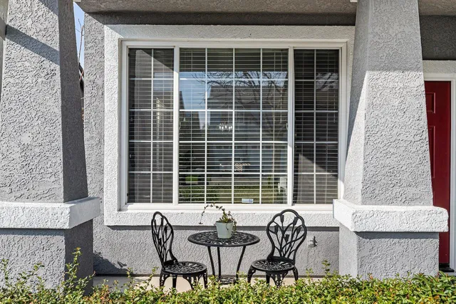 a living room with furniture a window and wooden floor