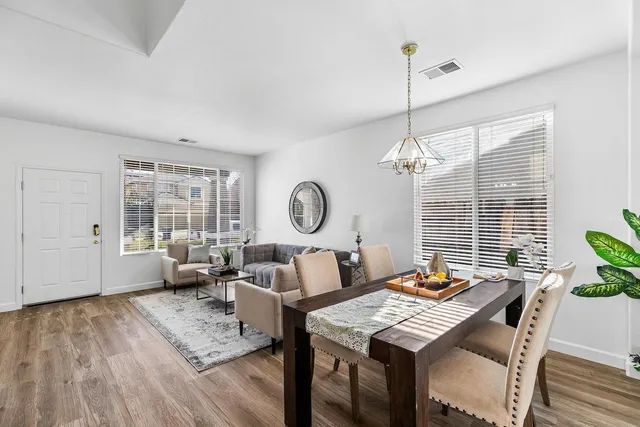 a living room with furniture a fireplace and a floor to ceiling window