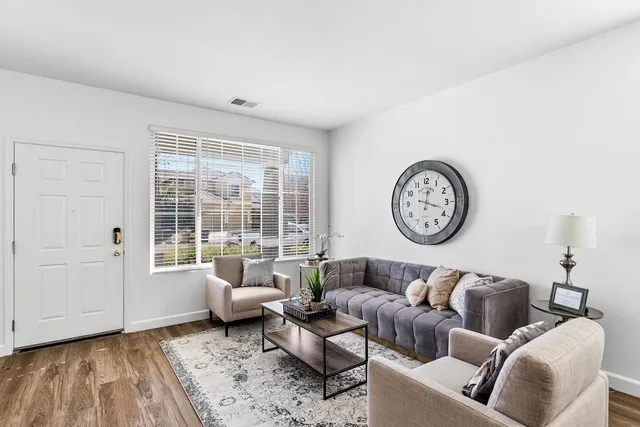 a living room with furniture fireplace and a window
