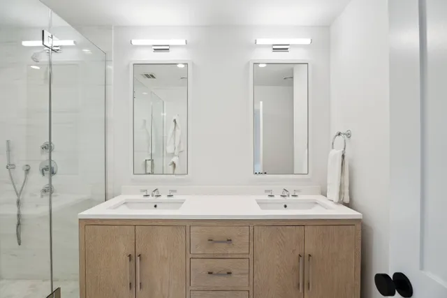a bathroom with a sink double vanity and a mirror