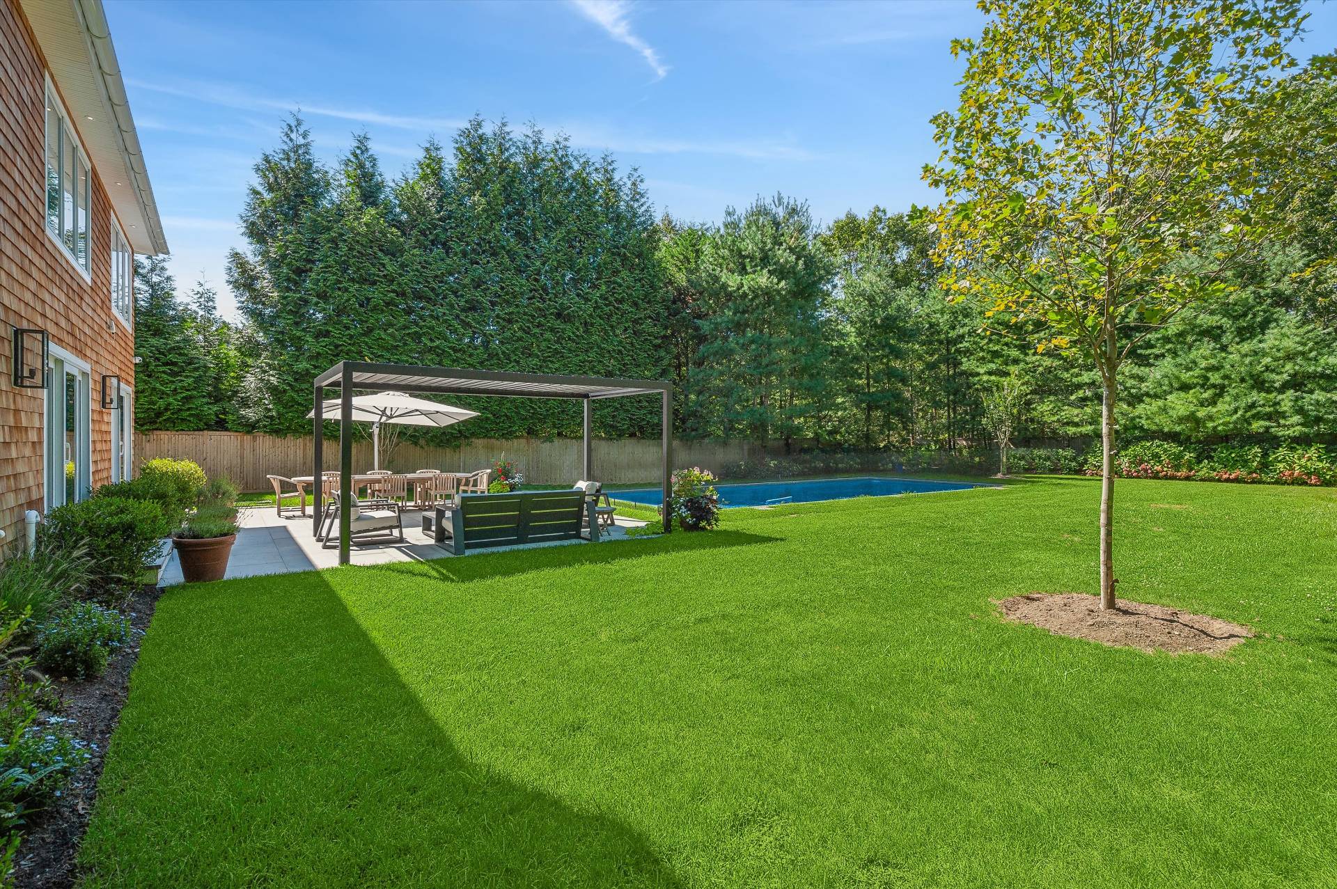 31 East Gate Road Wainscott, NY 11975 - Photo 16 of 20 a view of a house with backyard sitting area and garden