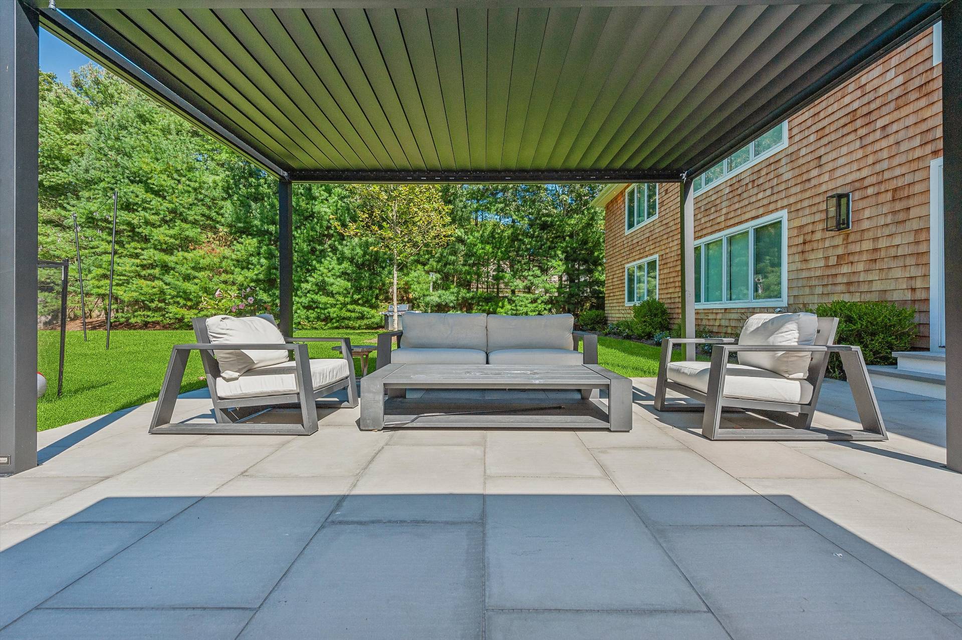 31 East Gate Road Wainscott, NY 11975 - Photo 17 of 20 a patio view with a garden and outdoor seating