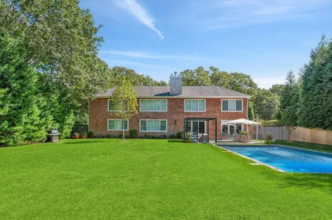 a house view with a sitting space and garden