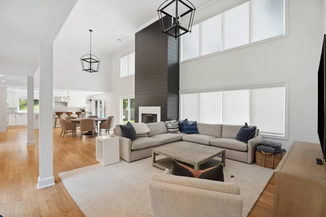 a living room with fireplace furniture and a wooden floor