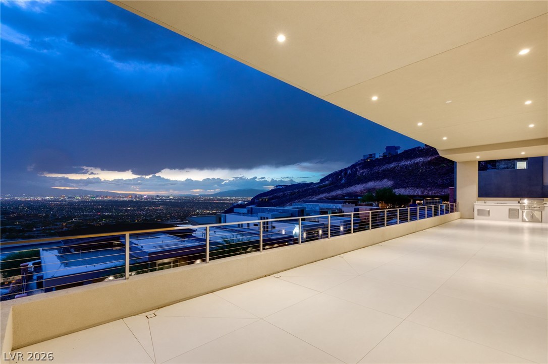 677 Overlook Rim Drive Henderson, NV 89012 - Photo 79 of 97 An expansive covered terrace framing panoramic city light and mountain views.