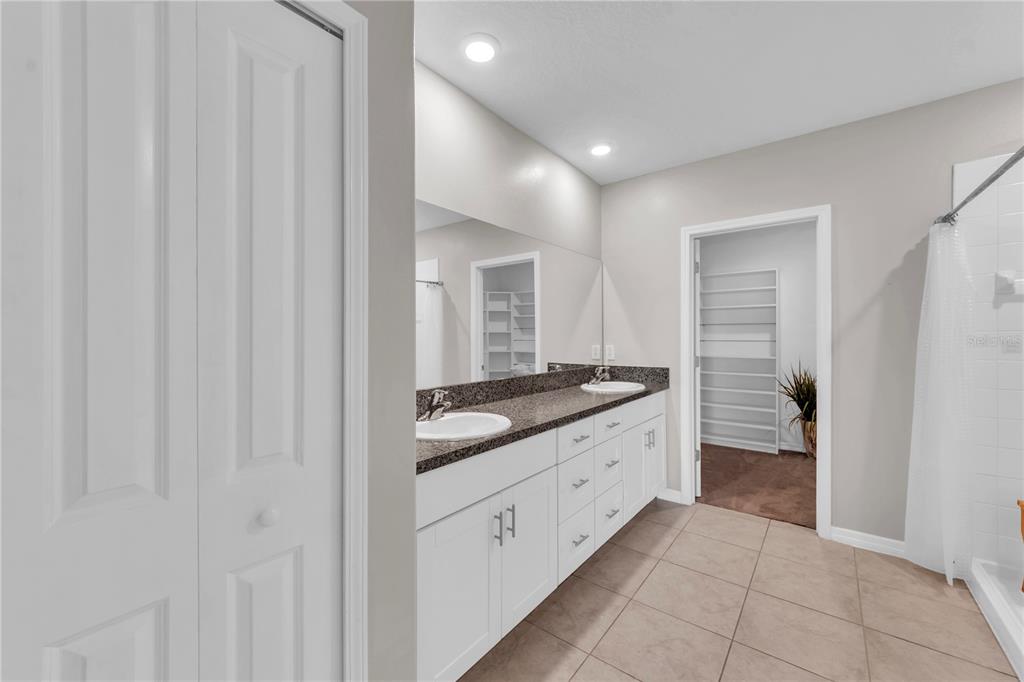 4215 Hanover Drive New Port Richey, FL 34653 - Photo 16 of 46 a bathroom with a granite countertop sink and a mirror