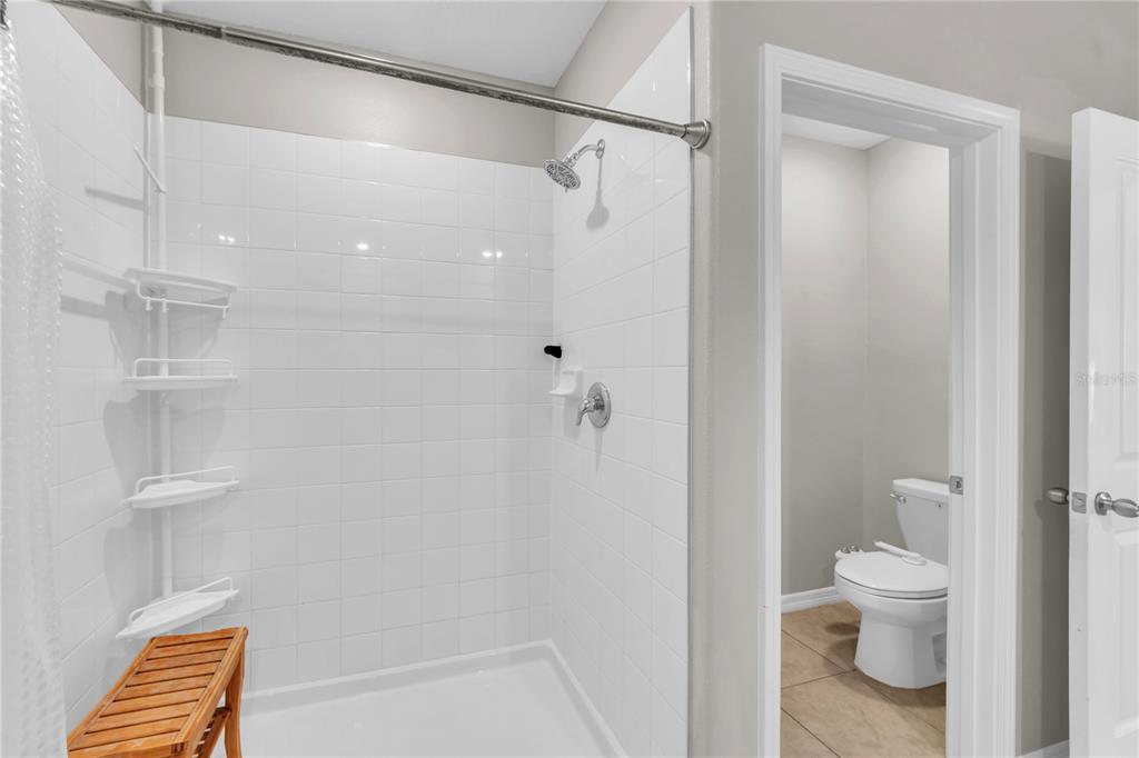 4215 Hanover Drive New Port Richey, FL 34653 - Photo 17 of 46 a bathroom with a shower and a toilet