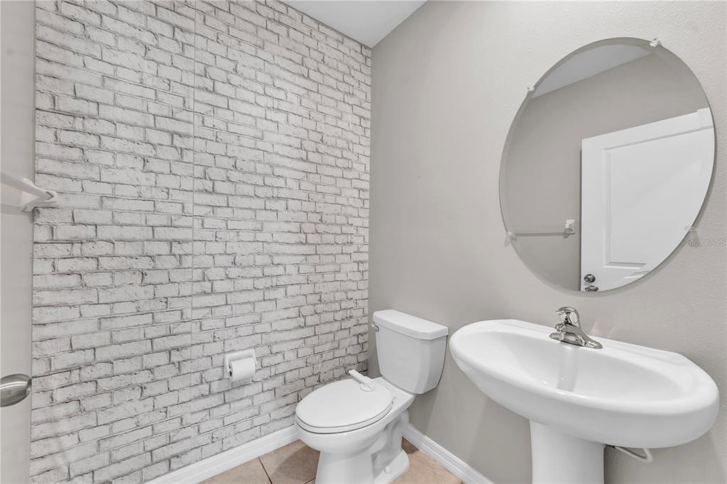 4215 Hanover Drive New Port Richey, FL 34653 - Photo 19 of 46 a bathroom with a sink a toilet and a mirror