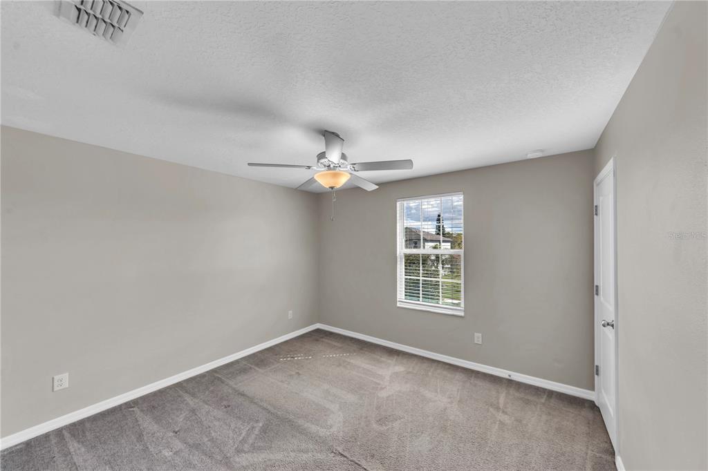 4215 Hanover Drive New Port Richey, FL 34653 - Photo 27 of 46 an empty room with windows and fan