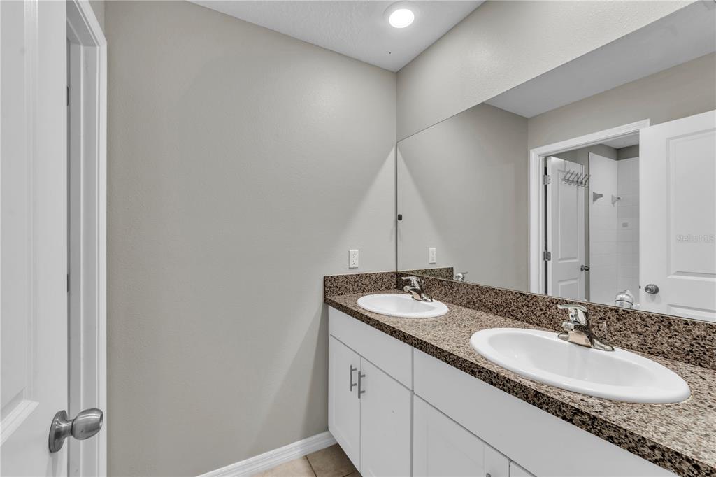 4215 Hanover Drive New Port Richey, FL 34653 - Photo 28 of 46 a bathroom with a granite countertop sink and a mirror