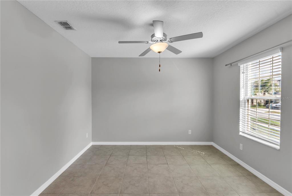 4215 Hanover Drive New Port Richey, FL 34653 - Photo 7 of 46 an empty room with windows and fan