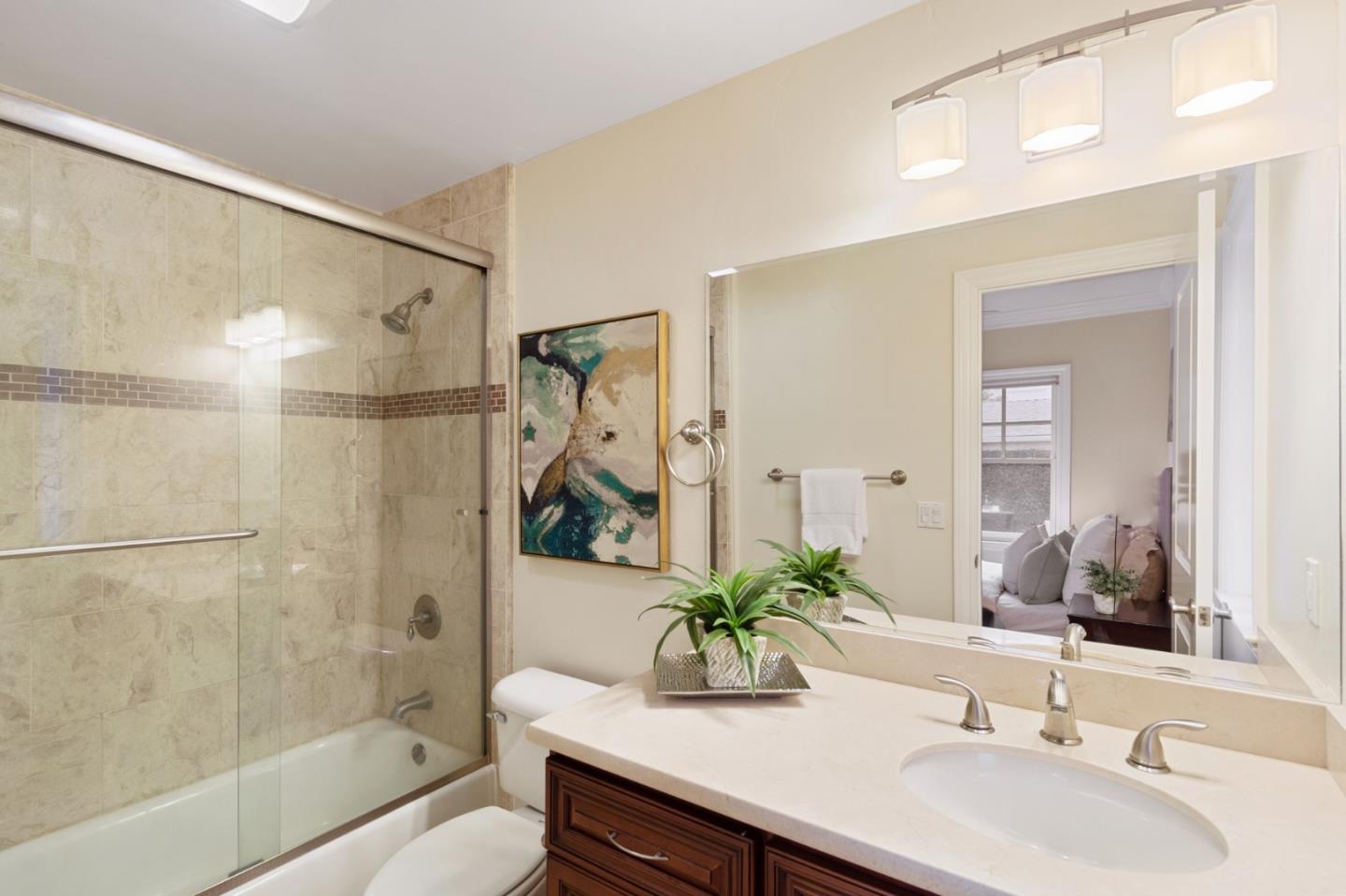 1665 Collingwood Avenue San Jose, CA 95125 - Photo 32 of 41 a bathroom with a granite countertop sink a mirror a bathtub and shower