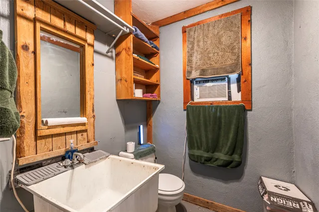 a bed sitting in a spacious bedroom next to a window