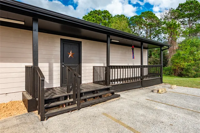 a view of a backyard with a fence
