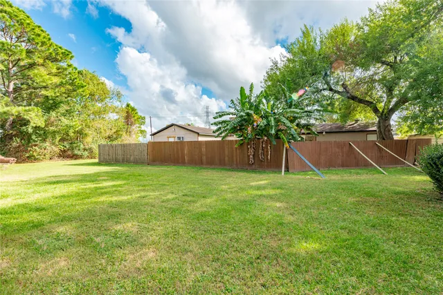 a view of a house with a yard and sitting area