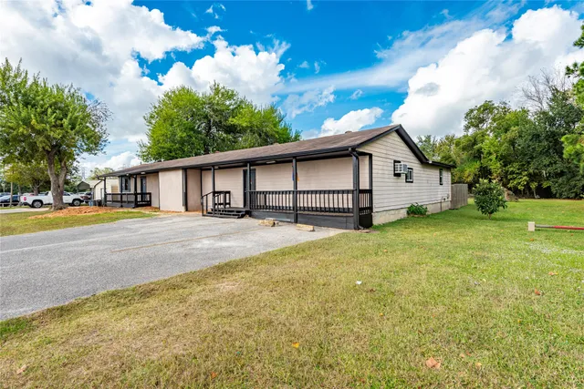 a house view with swimming pool and garden