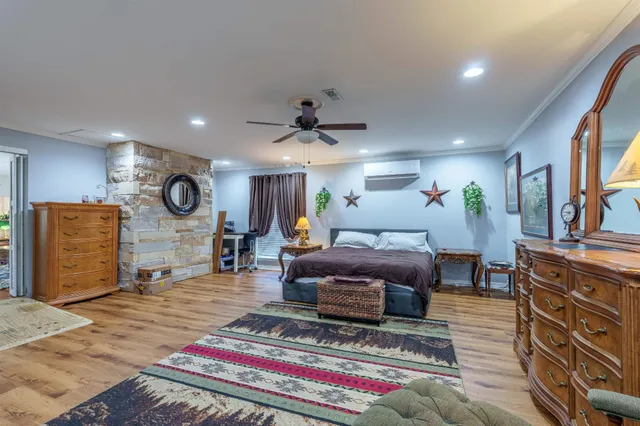 a living room with furniture a flat screen tv and a table