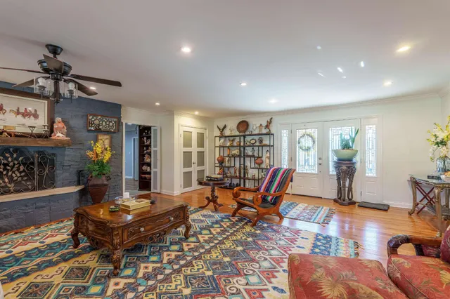 a living room with furniture a rug and a chandelier
