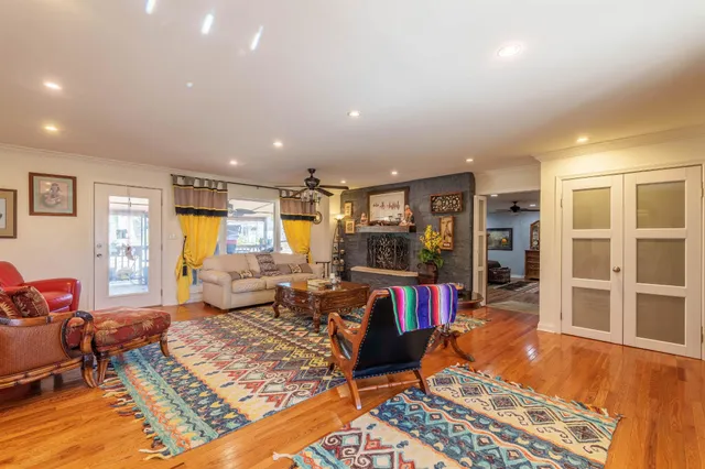 a living room with furniture a rug and a flat screen tv