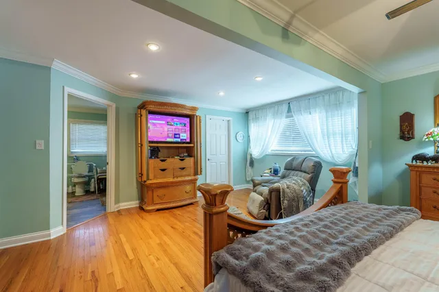 a bedroom with furniture and a flat screen tv