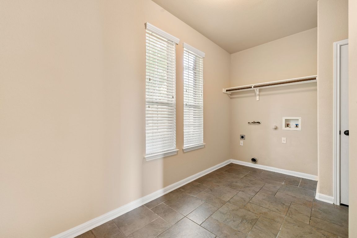 676 Rusk Road Round Rock, TX 78665 - Photo 28 of 35 Large laundry room tucked behind the formal dining/kitchen