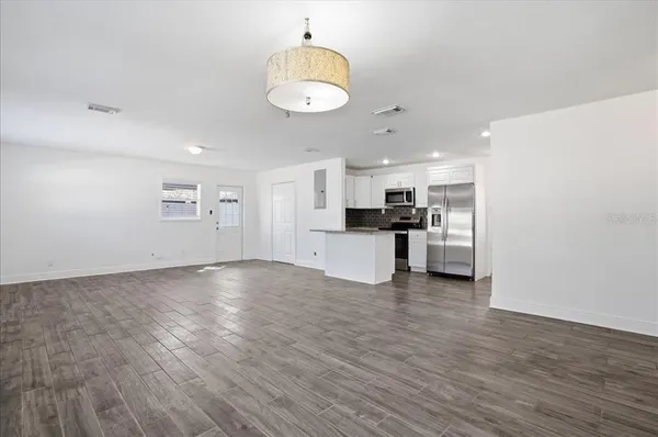 a view of kitchen with wooden floor and window
