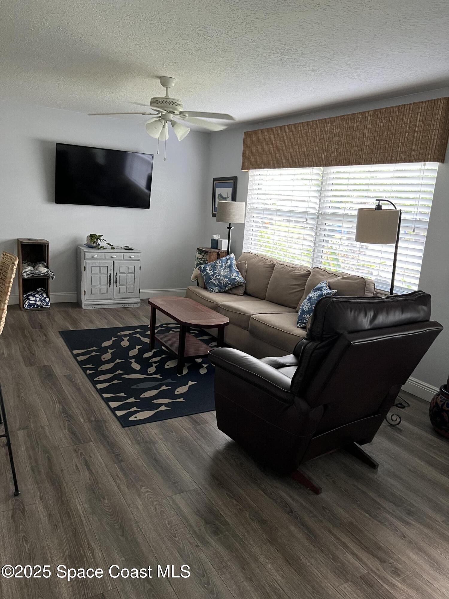 821 Hanover Court Rockledge, FL 32955 - Photo 4 of 15 a living room with furniture and a flat screen tv