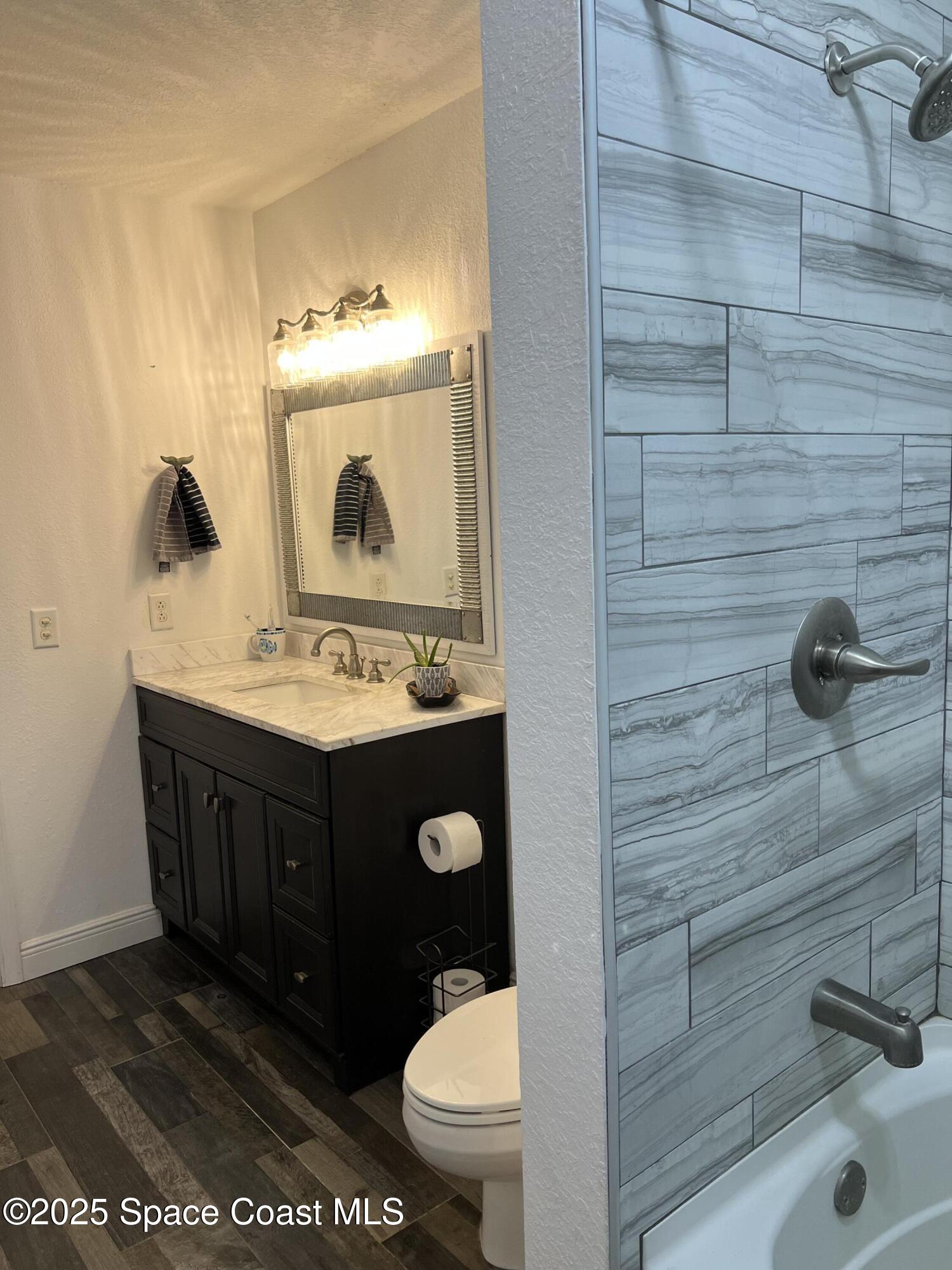 821 Hanover Court Rockledge, FL 32955 - Photo 8 of 15 a bathroom with a sink a toilet and mirror