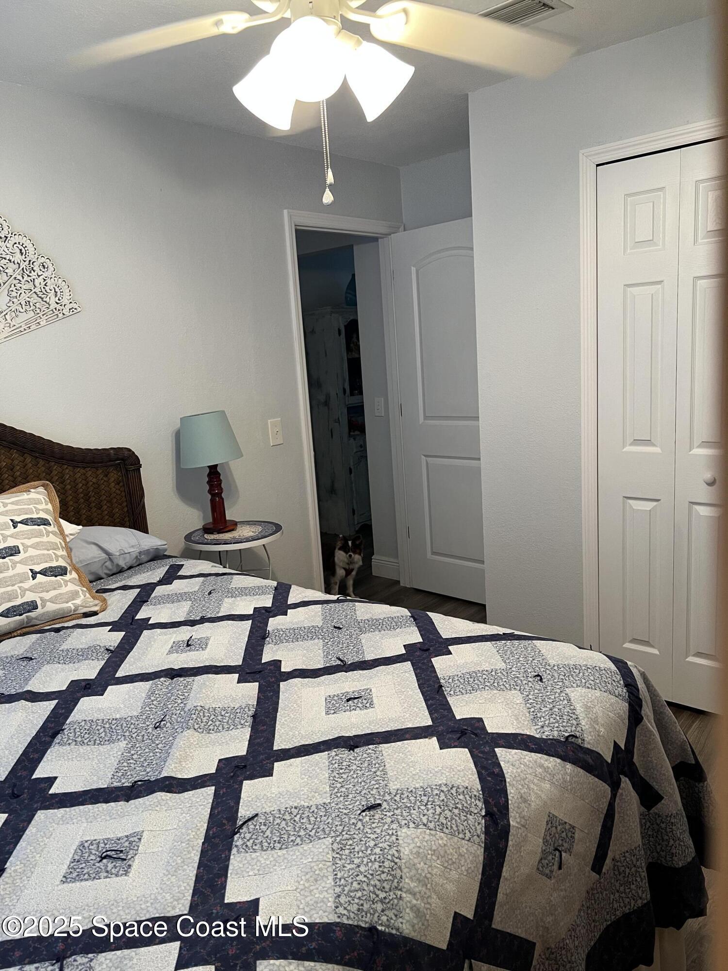 821 Hanover Court Rockledge, FL 32955 - Photo 10 of 15 a bedroom with a bed and a mirror