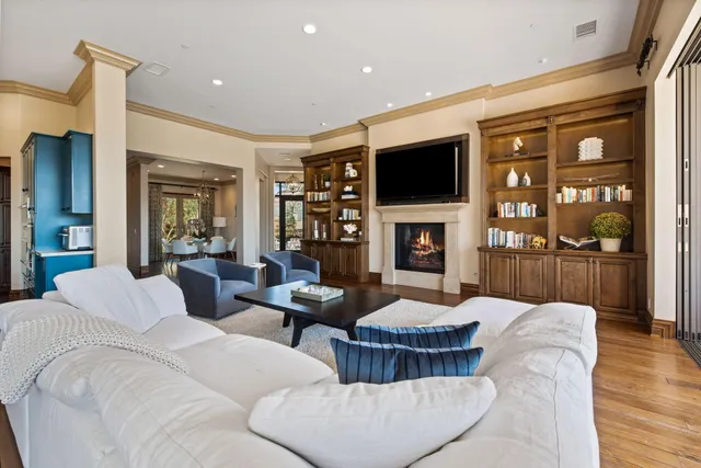 a living room with fireplace furniture and a flat screen tv