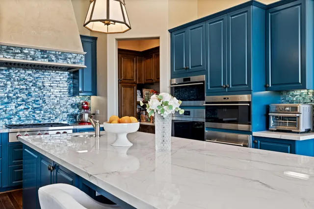 a kitchen with a stove and a refrigerator