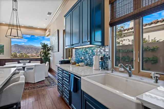 a kitchen with a table chairs stove and wooden floor