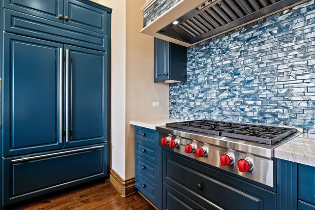 a kitchen with stainless steel appliances kitchen island granite countertop a dining table and chairs