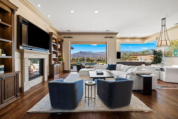 a living room with couches a coffee table and a flat screen tv