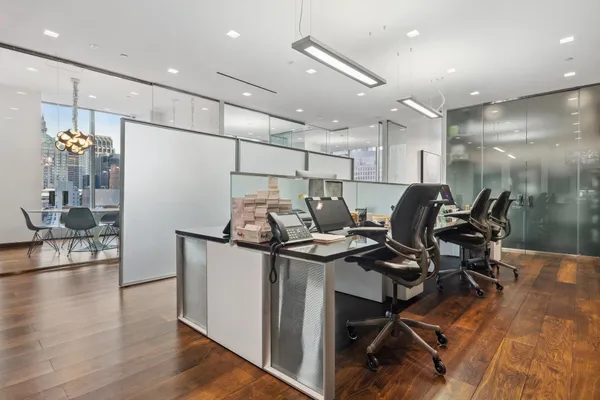 a work room with furniture and wooden floor