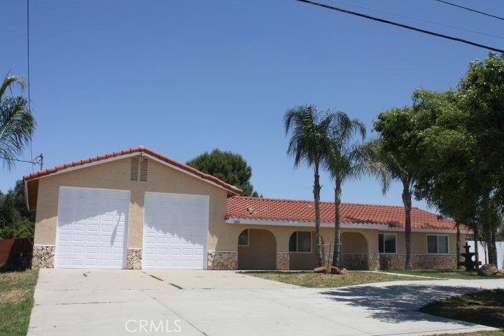 28526 Watson Road Menifee, CA 92585 - Photo 1 of 1 a front view of a house with a garden