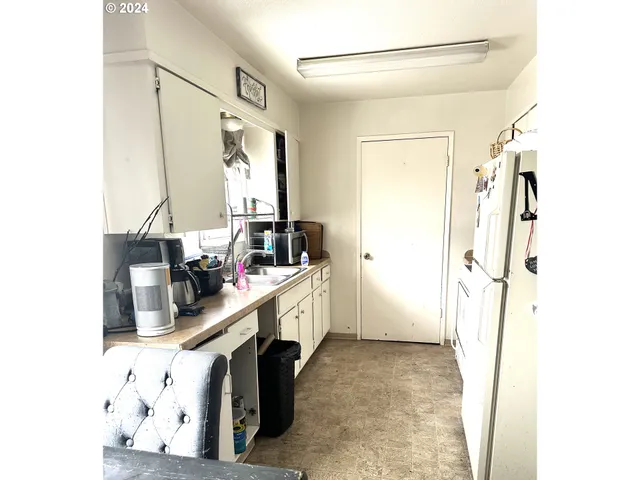 a kitchen with a sink a refrigerator and a stove