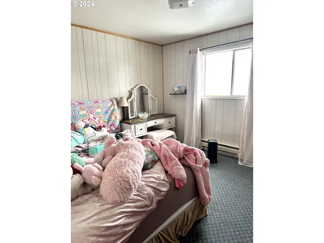 a bed sitting in a bedroom next to a window