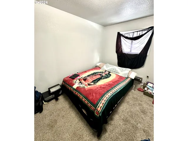 a bedroom with a bed and a table in it