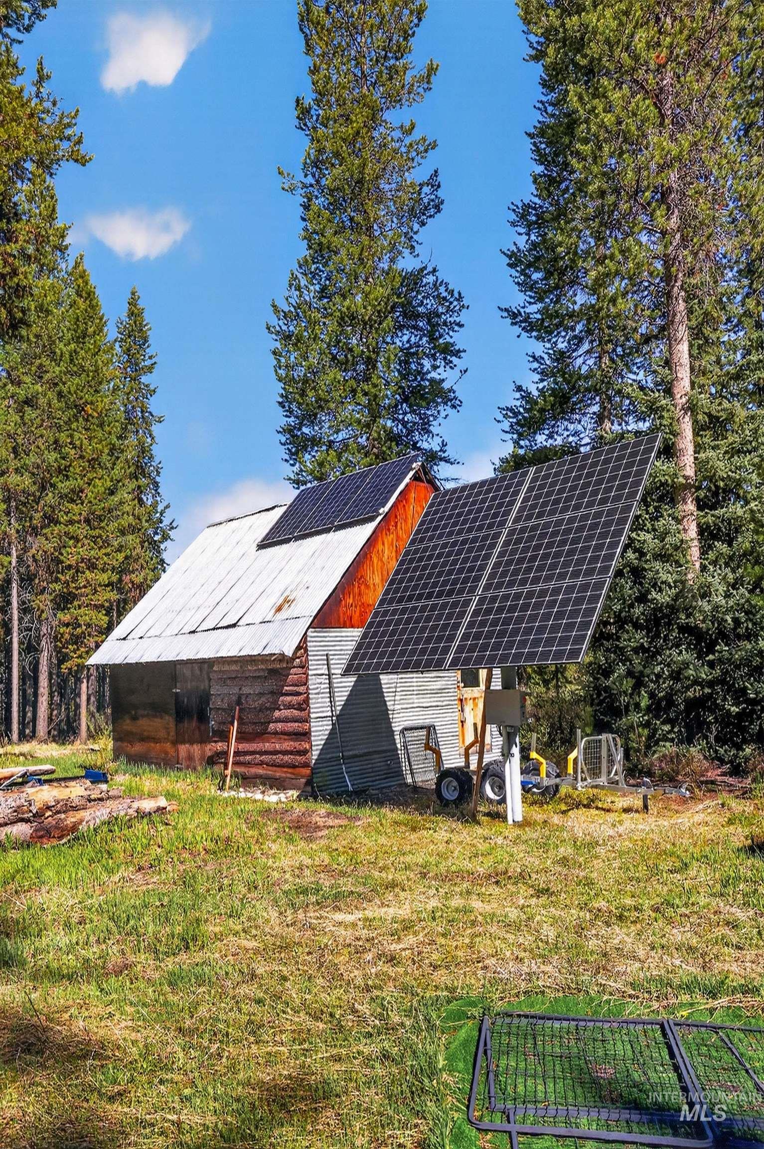 321 Secesh River Road McCall, ID 83638 - Photo 35 of 50 Rustic timber structure featuring a corrugated metal roof and integrated solar panels