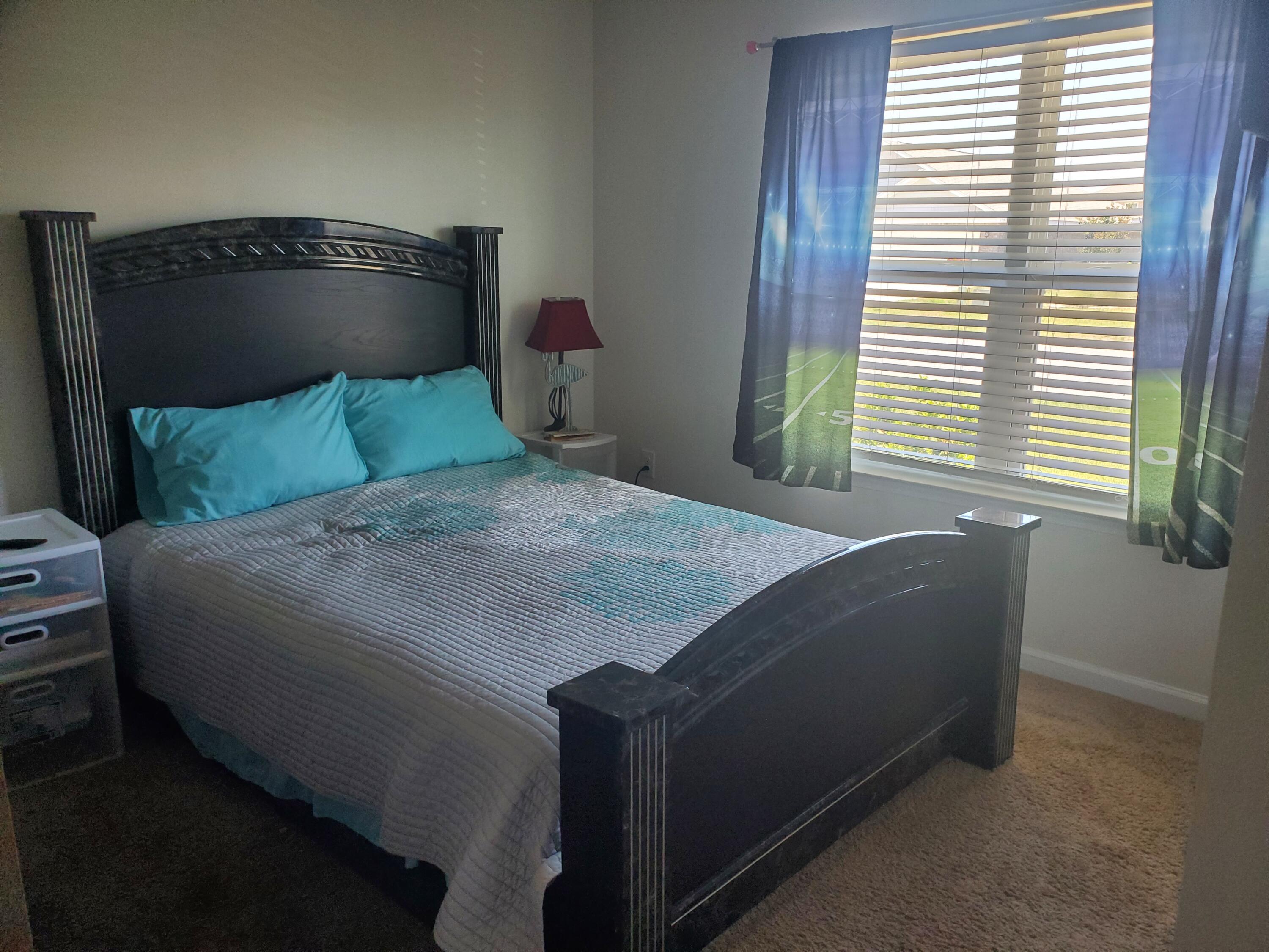 809 Moorhen Way Crestview, FL 32539 - Photo 17 of 24 a bedroom with a bed and a window
