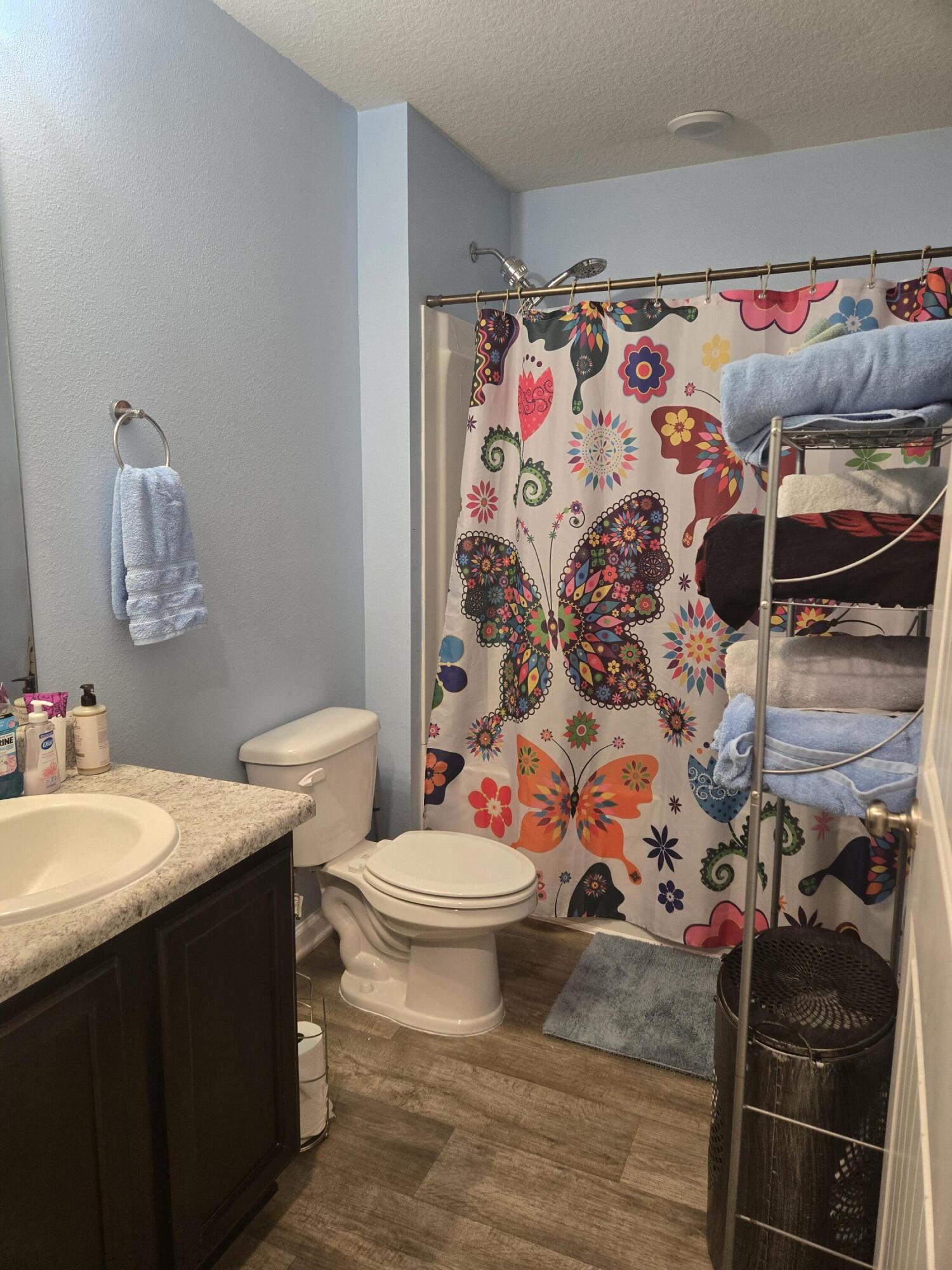 809 Moorhen Way Crestview, FL 32539 - Photo 18 of 24 a bathroom with a sink toilet and shower curtain