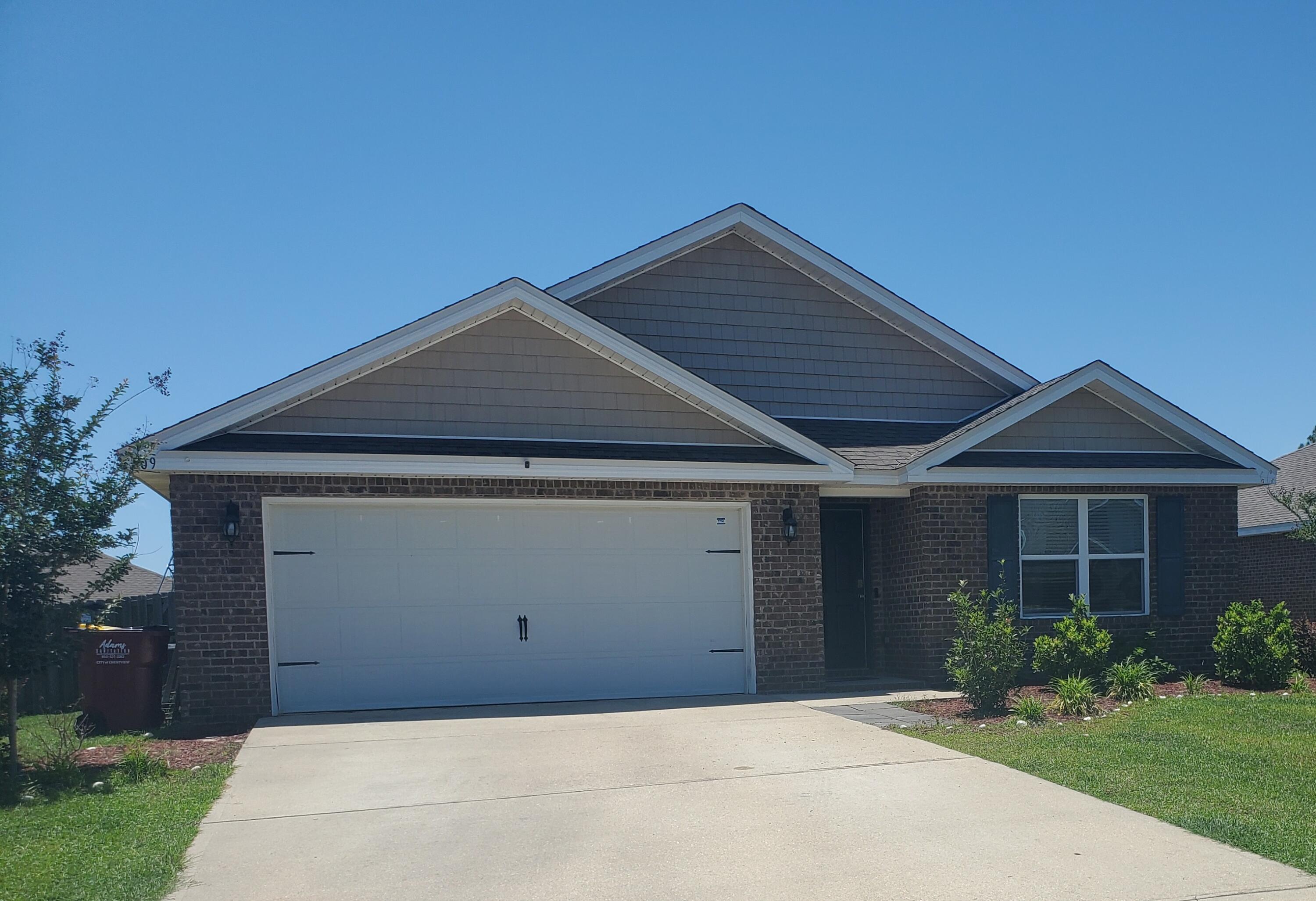809 Moorhen Way Crestview, FL 32539 - Photo 2 of 24 a front view of a house with a yard