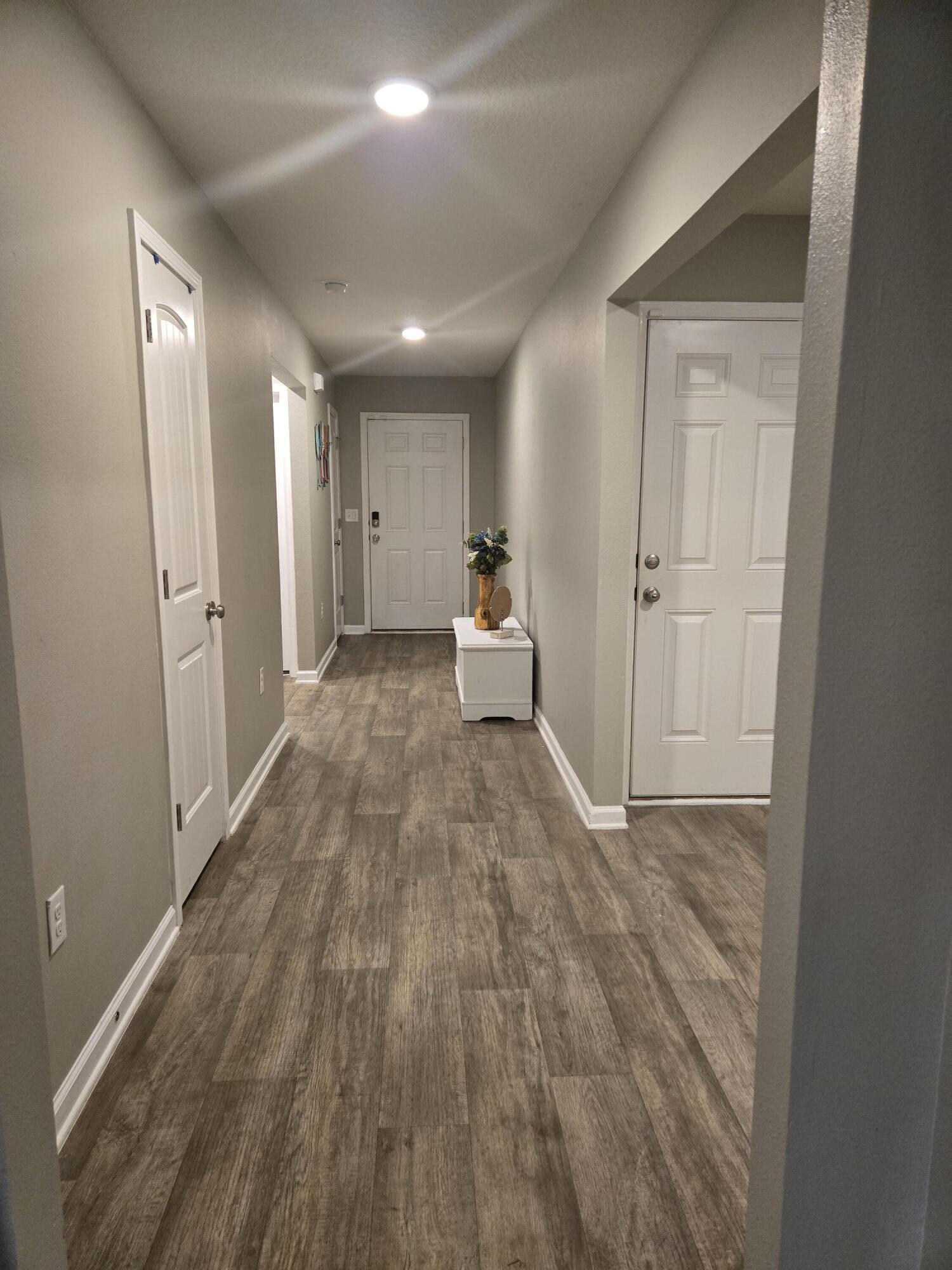 809 Moorhen Way Crestview, FL 32539 - Photo 4 of 24 a view of empty room with wooden floor