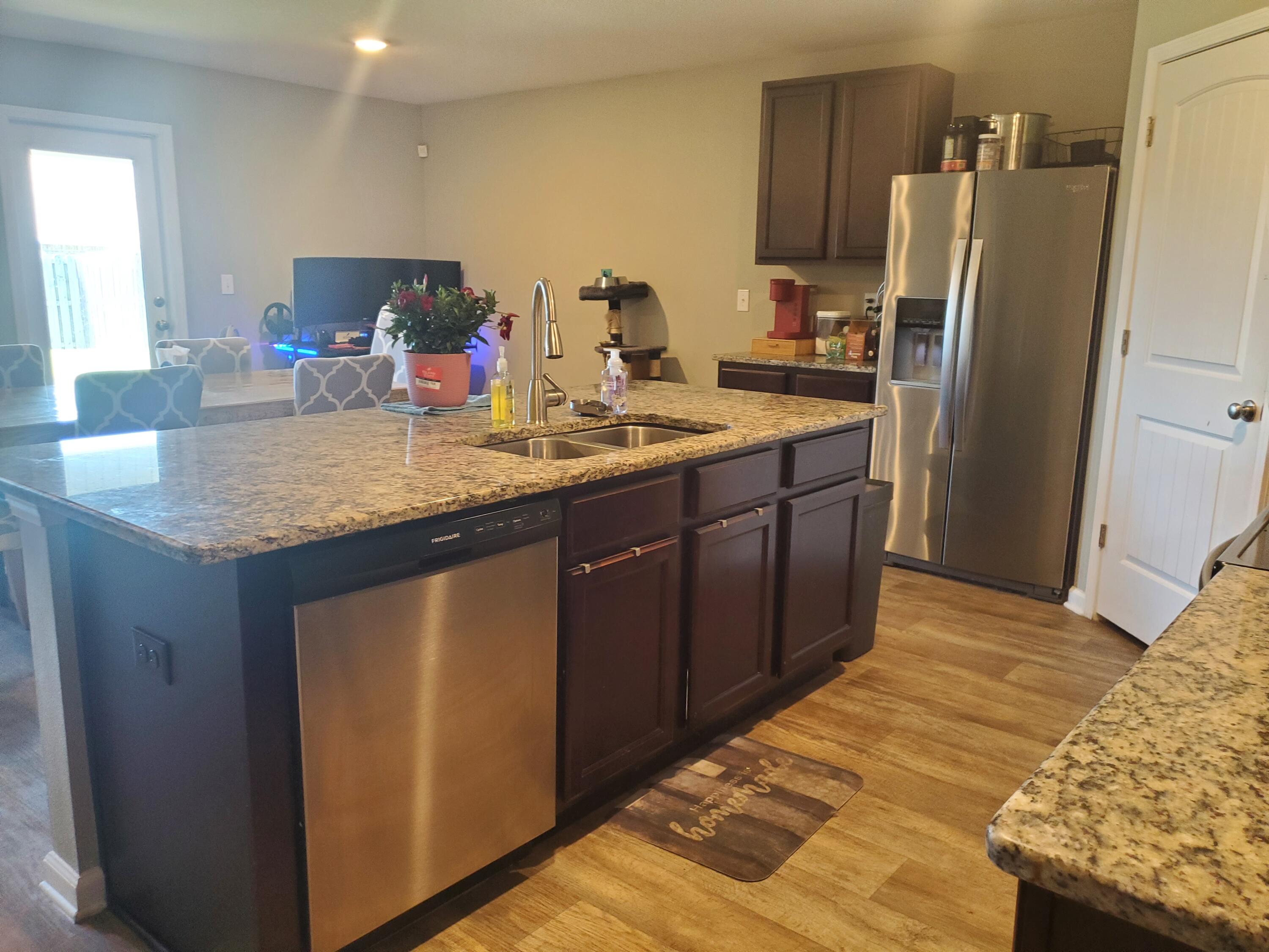 809 Moorhen Way Crestview, FL 32539 - Photo 9 of 24 a kitchen with stainless steel appliances granite countertop a sink stove and refrigerator