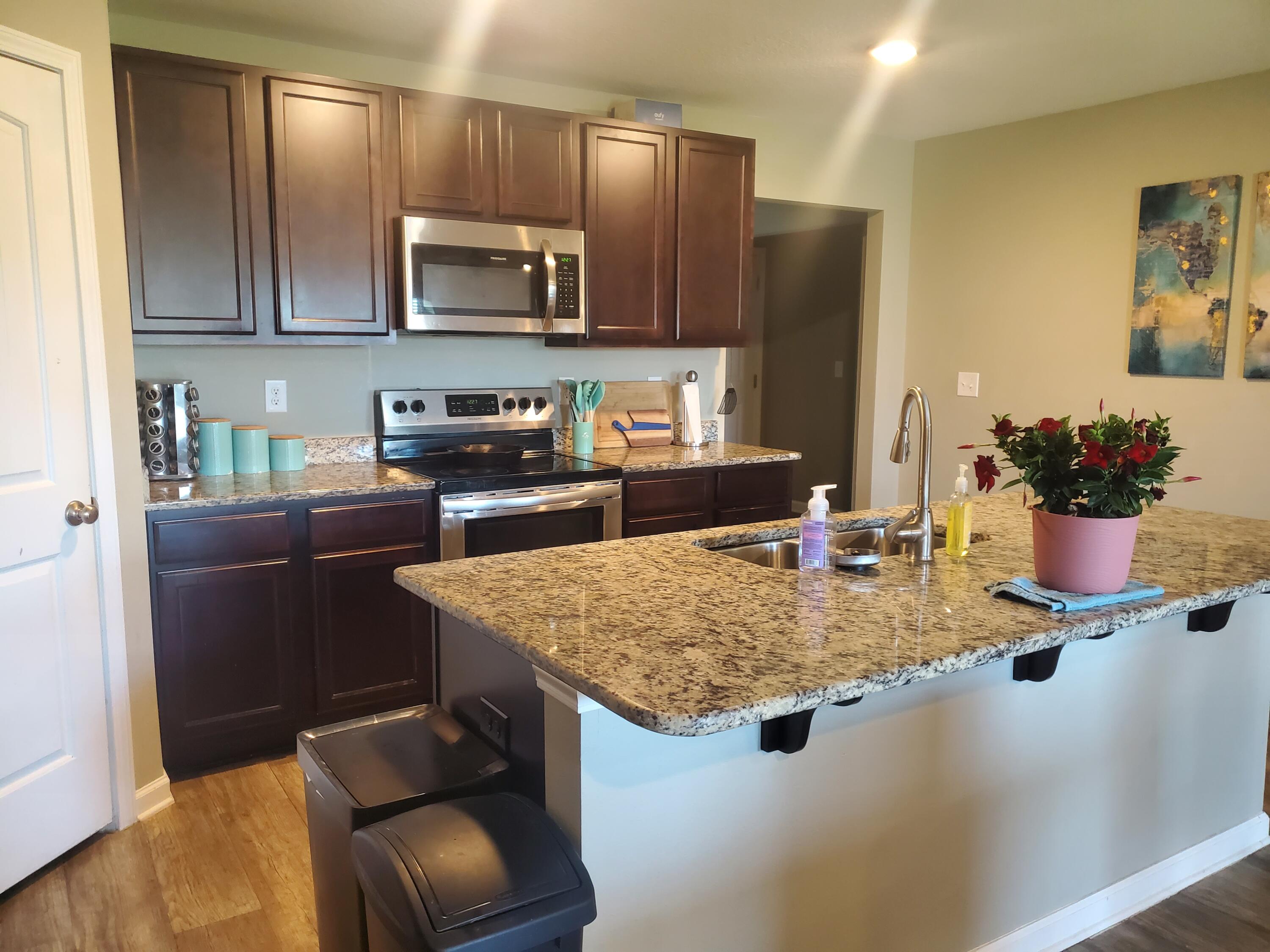 809 Moorhen Way Crestview, FL 32539 - Photo 10 of 24 a kitchen with stainless steel appliances granite countertop a sink dishwasher stove and refrigerator