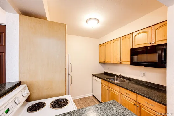 a kitchen with a stove and a refrigerator