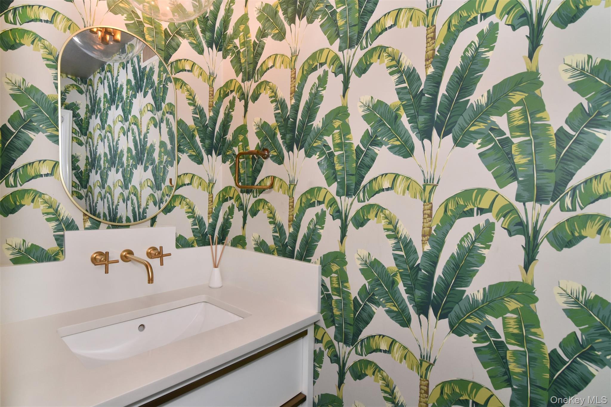 30 Locust Lane Bronxville, NY 10708 - Photo 12 of 28 a bathroom with a sink and mirror with garden view