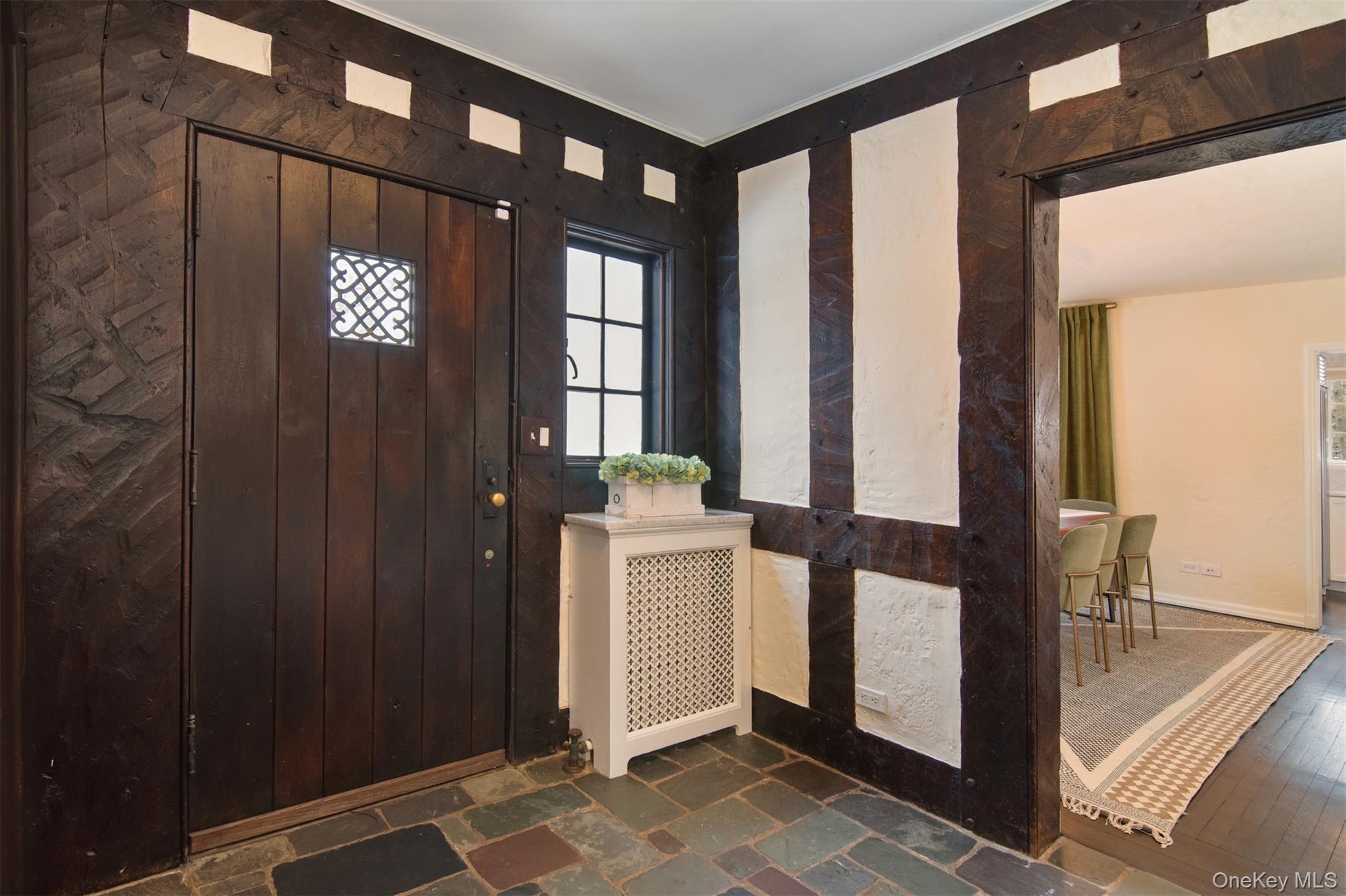 30 Locust Lane Bronxville, NY 10708 - Photo 13 of 28 a view of a hallway with dining area and chandelier
