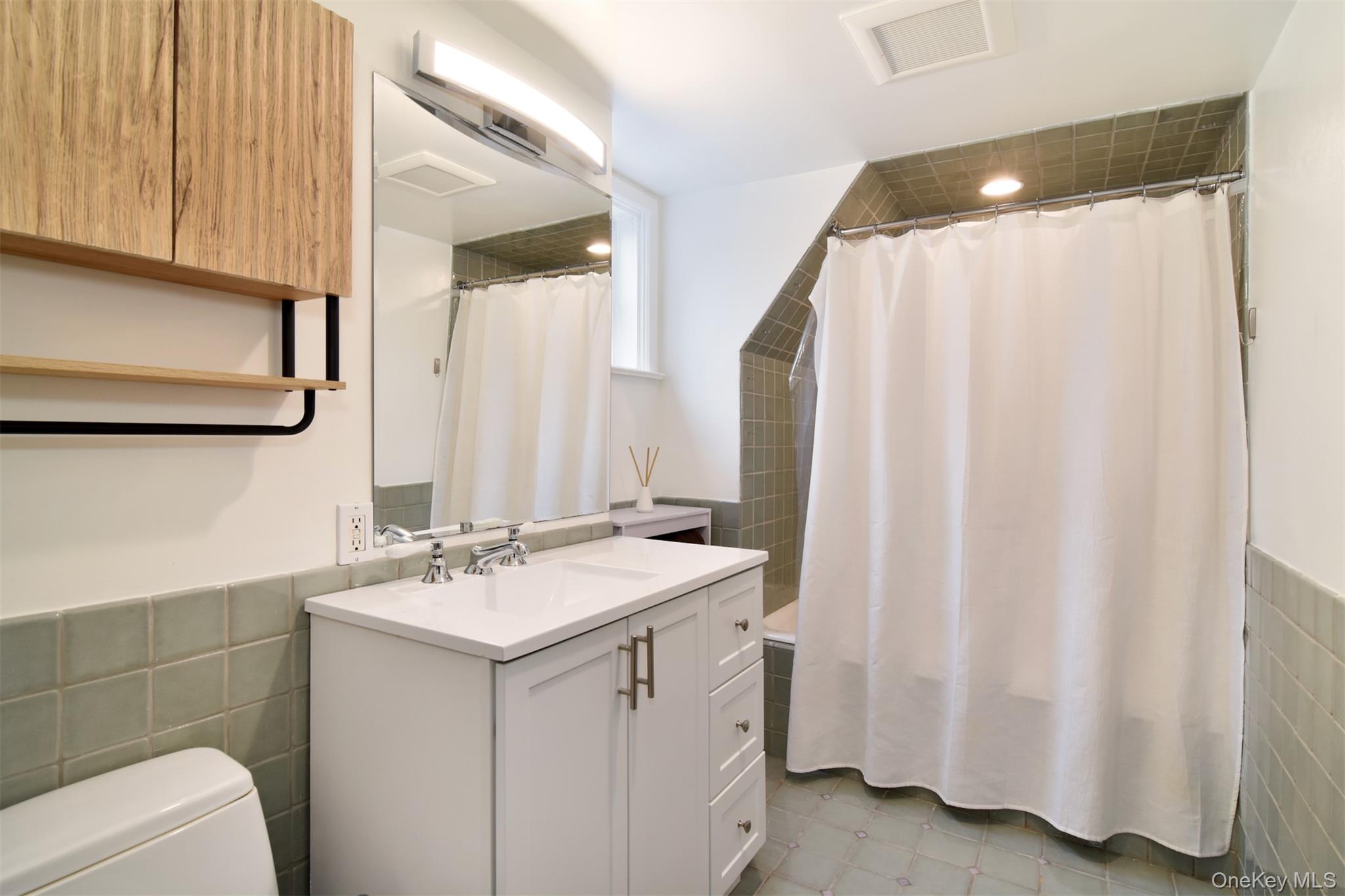 30 Locust Lane Bronxville, NY 10708 - Photo 19 of 28 a bathroom with a sink and a mirror